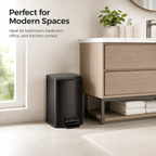 Black square pedal trash can placed in a modern bathroom beside a wooden vanity